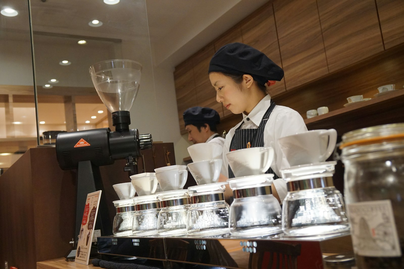 Barista working behind the espresso bar at Brew & Bean Cafe