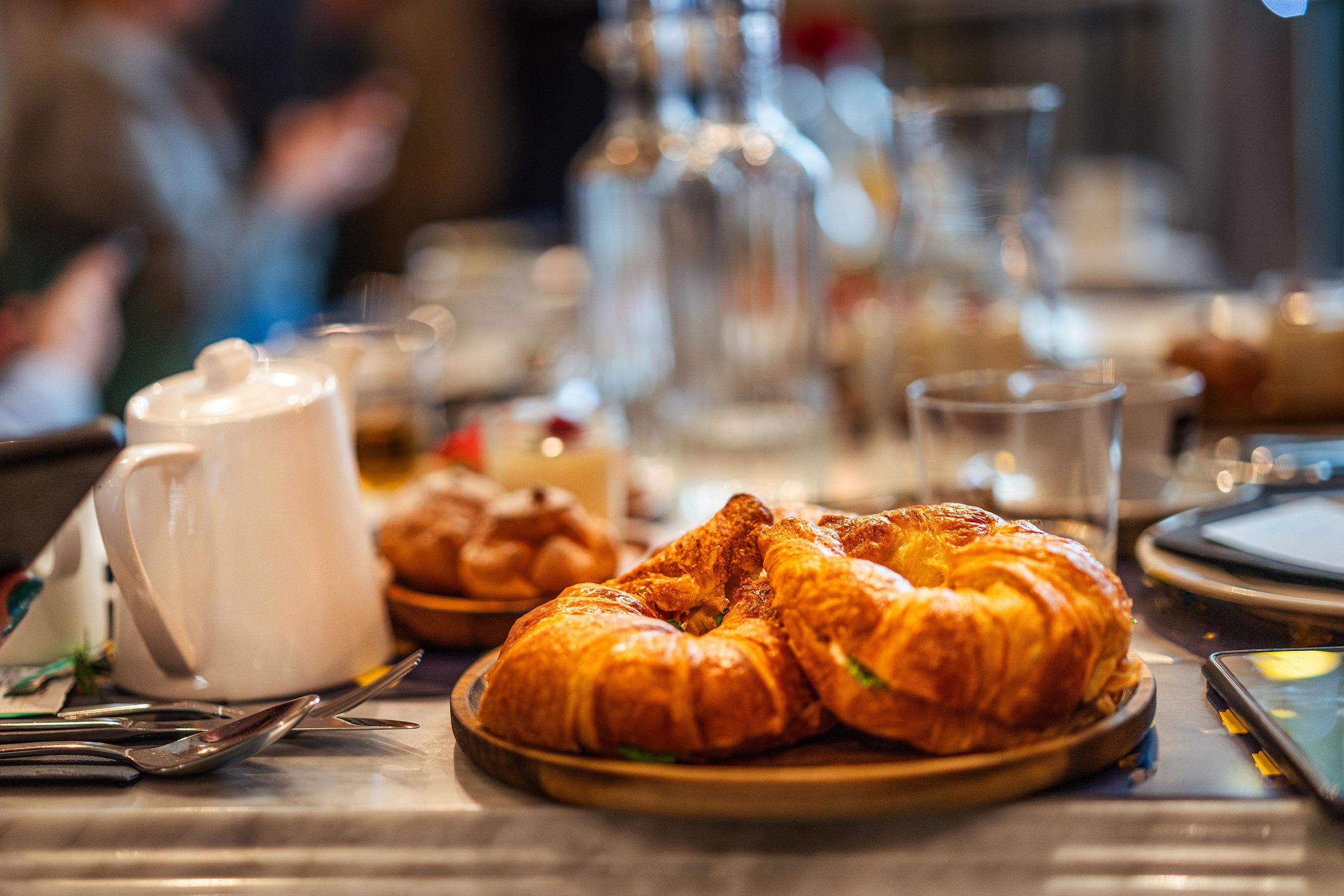 Fresh pastries and brunch plates on a cafe table