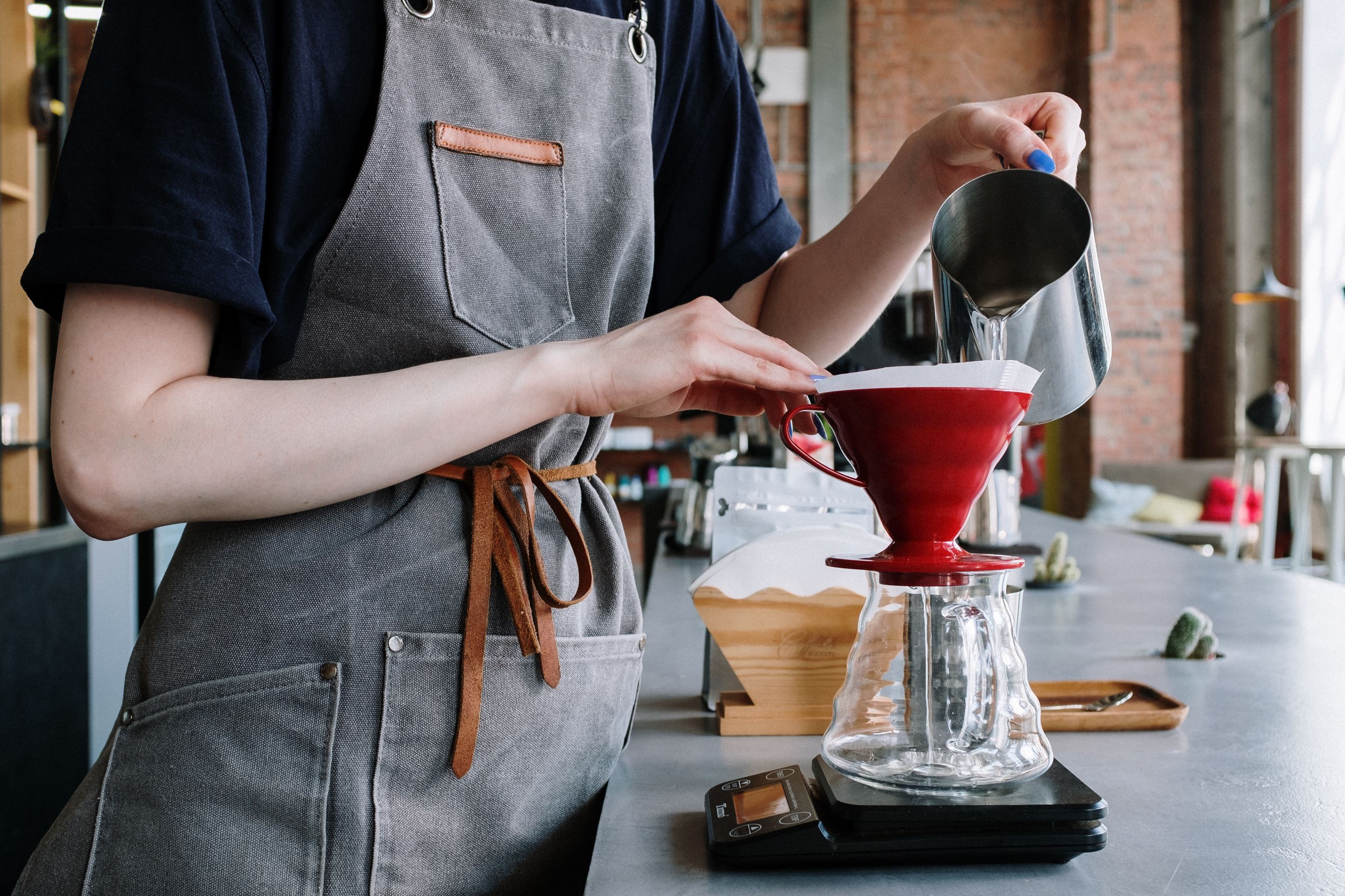 Barista preparing a pour-over coffee at Brew & Bean Cafe